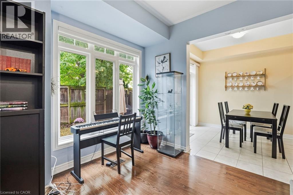 Hardwood-finish flooring, large window with backyard views, and a dedicated dining area with tile flooring - 1076 Ryckman Common, Burlington, ON