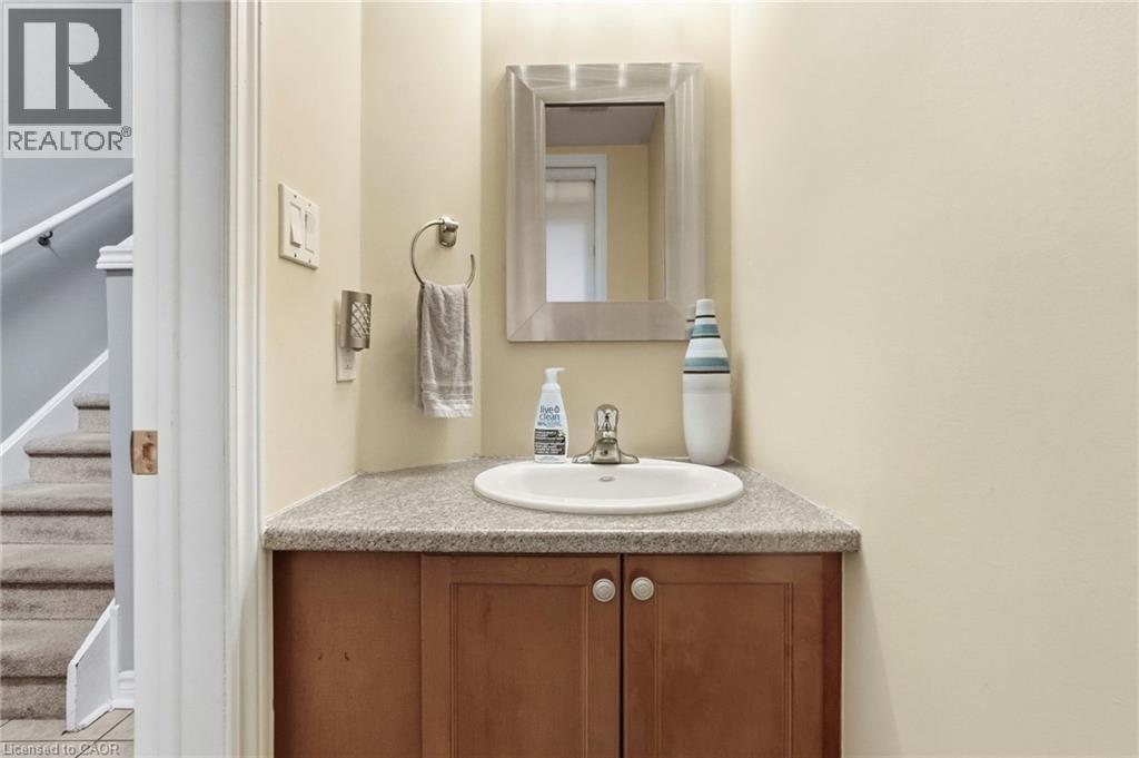 Corner vanity with a built-in sink and a light-toned countertop - 1076 Ryckman Common, Burlington, ON