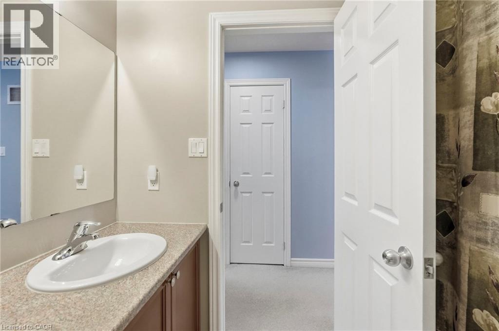Vanity with an integrated oval sink, chrome-finish faucet, and laminate countertop - 1076 Ryckman Common, Burlington, ON