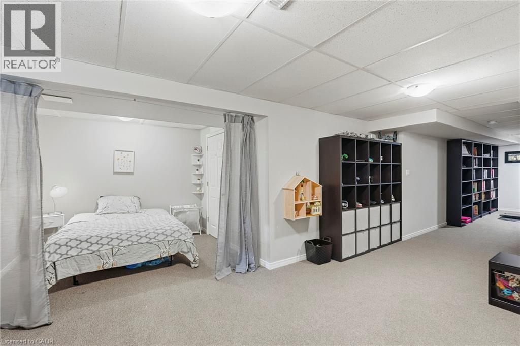 Recessed ceiling lighting, light gray wall paint, carpet flooring, and built-in shelving units - 1076 Ryckman Common, Burlington, ON