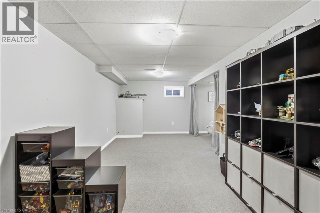 Finished lower level with neutral carpeting - 1076 Ryckman Common, Burlington, ON