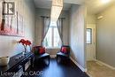 Wood-finish flooring, central window with grid pattern, and a prominent rectangular light fixture - 28 Madonna Drive, Hamilton, ON 