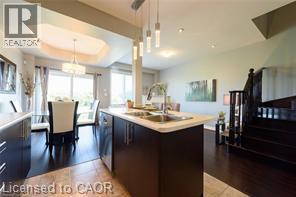 Kitchen island with undermount sink and contemporary pendant lighting - 28 Madonna Drive, Hamilton, ON