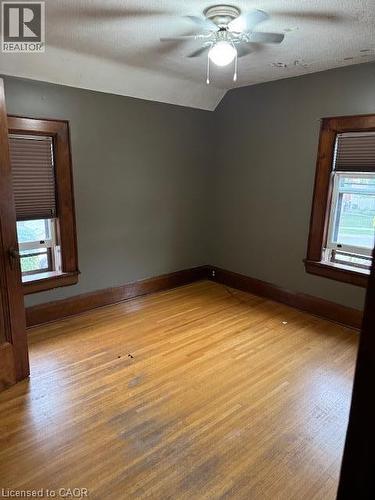 Hardwood flooring with wood-trim windows and a ceiling fan with integrated lighting - 255 Main Street, Cambridge, ON 