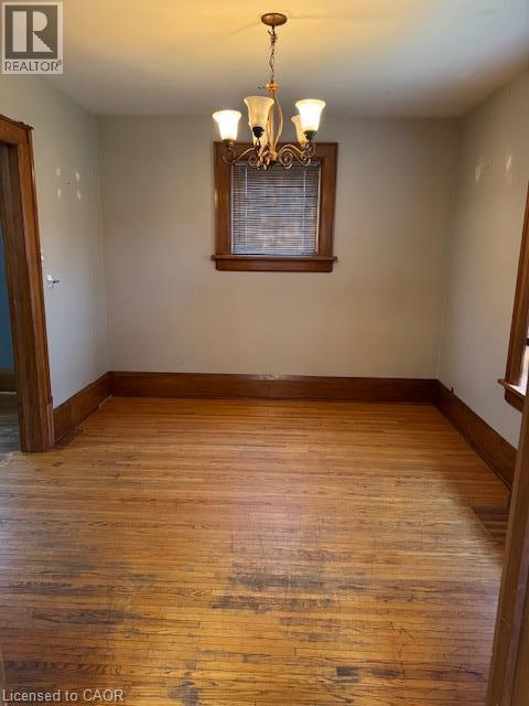 Hardwood flooring, wood window trim, wood door frames, and a bronze chandelier - 255 Main Street, Cambridge, ON