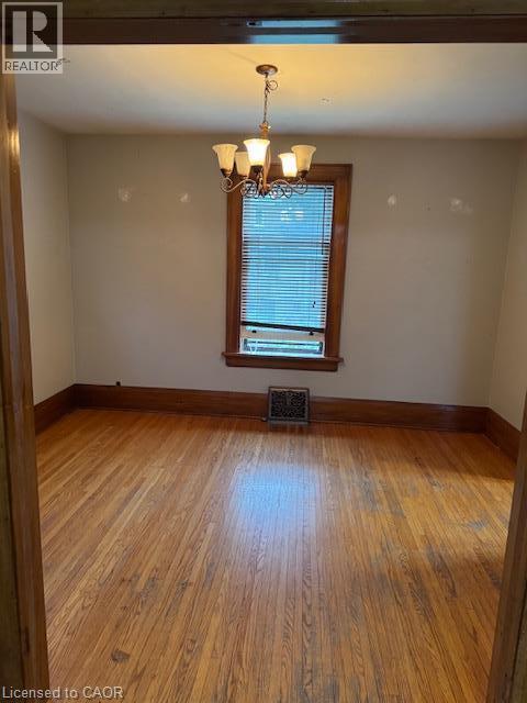 Hardwood flooring, decorative chandelier, wood trim, window with blinds - 255 Main Street, Cambridge, ON