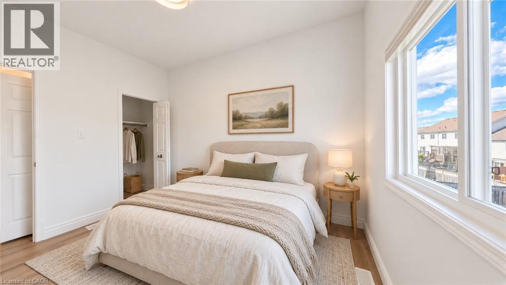 Wood-finish flooring, white walls, built-in closet, large window, and overhead lighting - 250 Parkvale Drive, Kitchener, ON