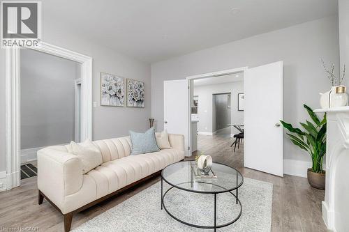 Recessed lighting, wood-finish flooring, white double doors, and decorative fireplace mantel - 125 Cathcart Street, Hamilton, ON 