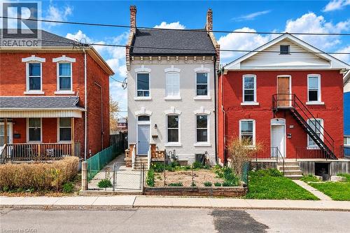 Light-toned brick exterior with white window trim - 125 Cathcart Street, Hamilton, ON 