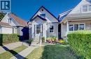 Front facade featuring painted brick and siding, a covered porch entrance, and a paved driveway - 3 Craigmiller Avenue, Hamilton, ON 