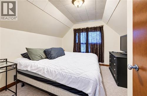 Carpeted room with sloped ceilings, recessed window, and flush-mount ceiling light - 3 Craigmiller Avenue, Hamilton, ON 