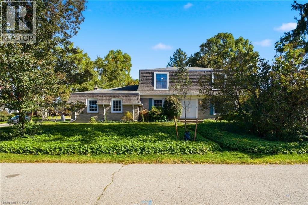 Gray exterior with white trim, featuring a distinctive Mansard roofline - 287 Blue Heron Ridge, Cambridge, ON