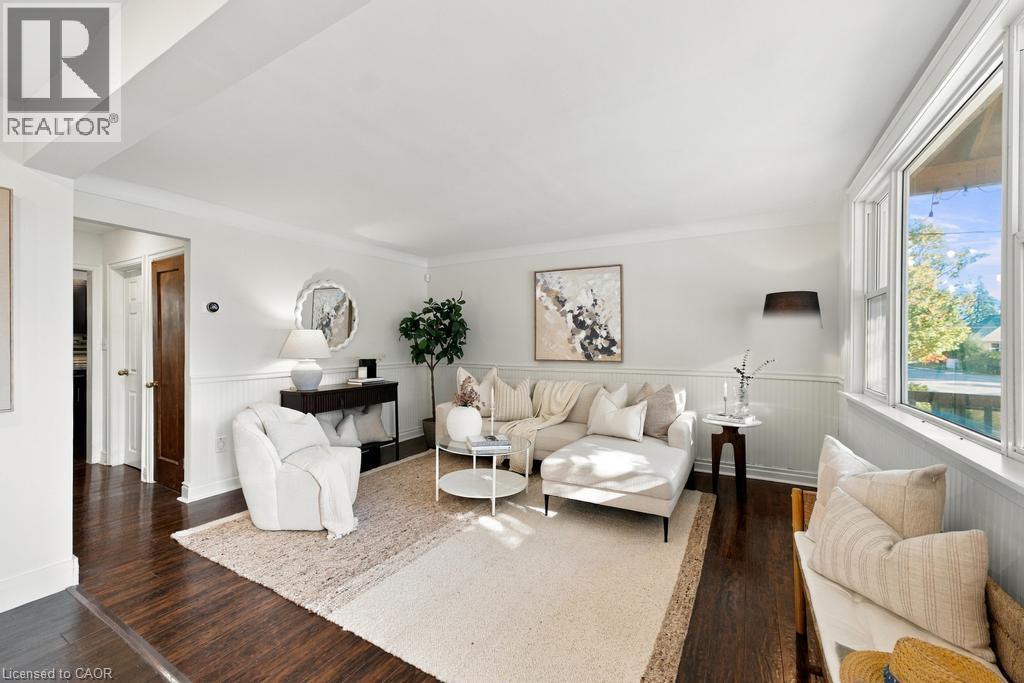 Hardwood-style flooring throughout, white beadboard paneling, white window trim, and white crown molding - 284 East 21St Street, Hamilton, ON