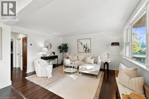 Hardwood-style flooring throughout, white beadboard paneling, white window trim, and white crown molding - 284 East 21St Street, Hamilton, ON 