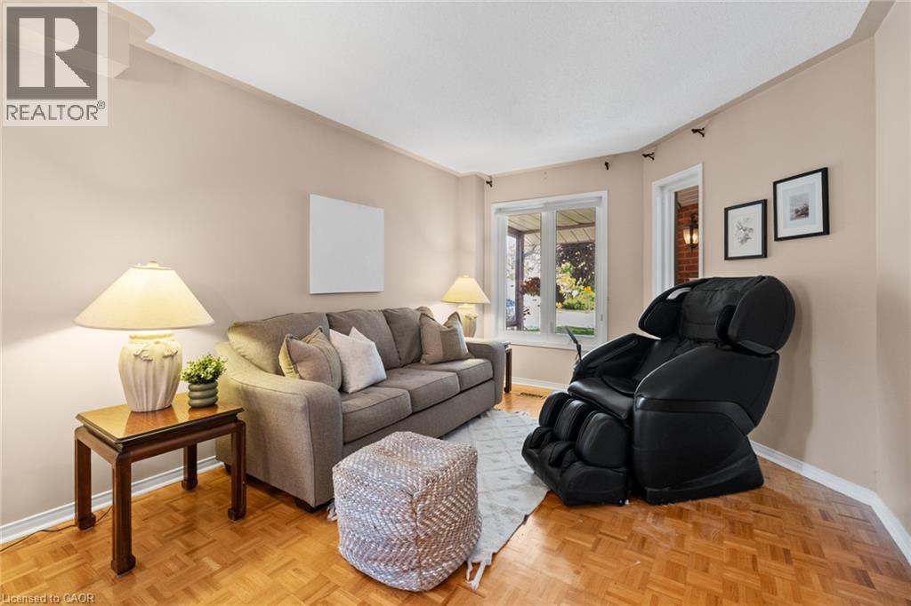 Parquet wood-finish flooring, neutral wall paint, white trim, and a prominent window - 1263 Bantham Street, Mississauga, ON