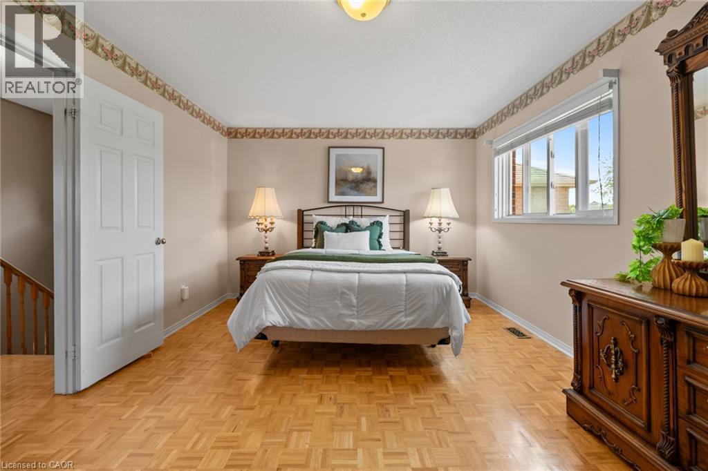 Parquet wood-finish flooring, white trim, and a window with blinds - 1263 Bantham Street, Mississauga, ON