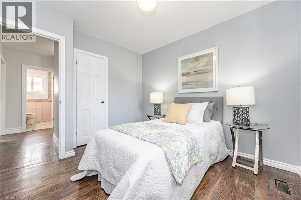 Wood-finish flooring throughout, light-toned wall paint, and white trim - 388 Appleby Line, Burlington, ON