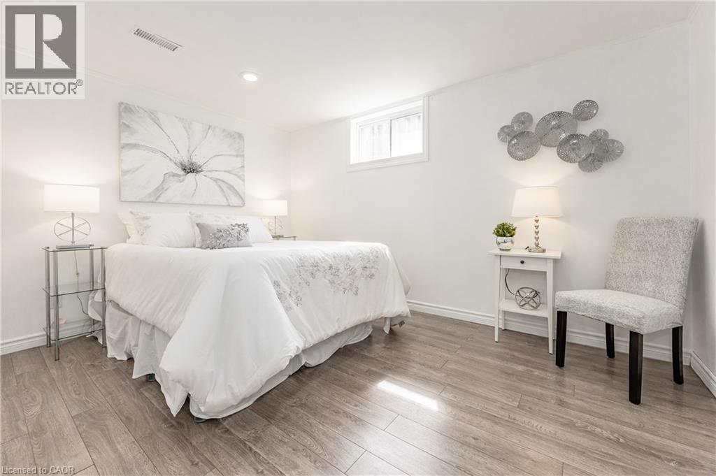 Wood-finish flooring throughout, recessed ceiling lighting, a single window, and white painted walls - 388 Appleby Line, Burlington, ON