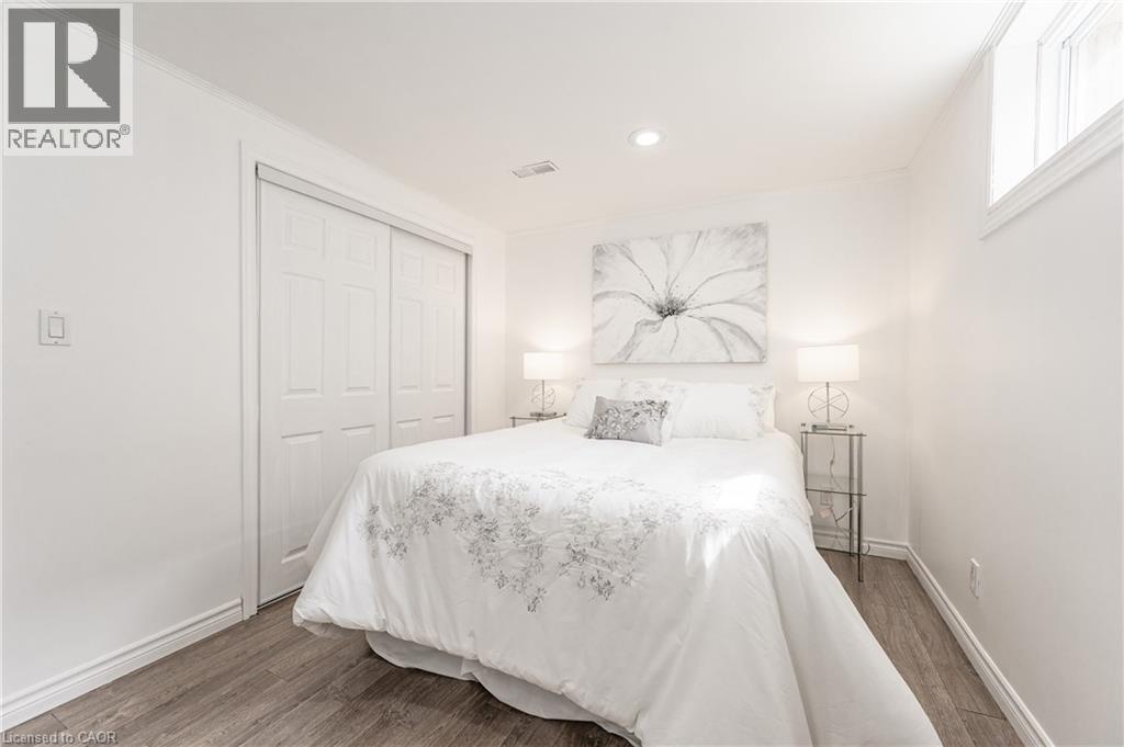 Wood-finish flooring, recessed lighting, double sliding closet doors, and an upper window - 388 Appleby Line, Burlington, ON