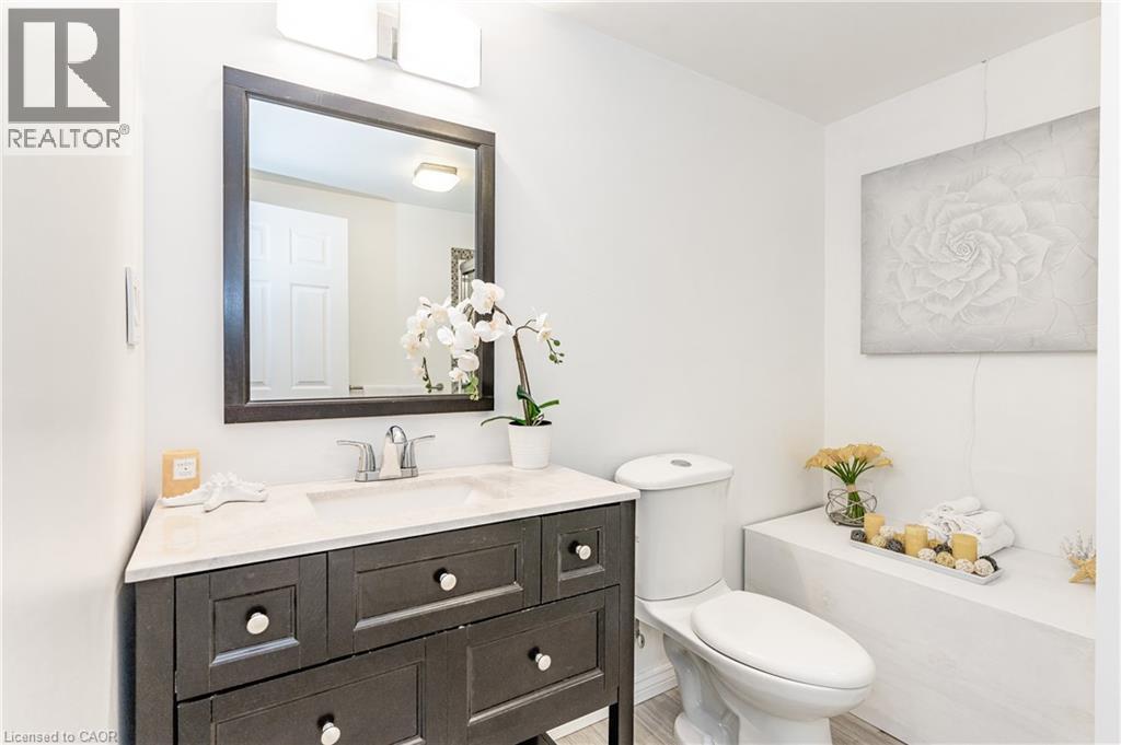 Dark wood-finish vanity with a light countertop and undermount sink - 388 Appleby Line, Burlington, ON