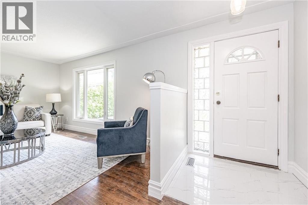 White paneled front door with an arched decorative glass insert and a glass block sidelight - 388 Appleby Line, Burlington, ON