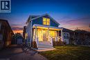 Two-story residence featuring blue siding, white trim, and a covered front porch - 1231 Dunsmure Road, Hamilton, ON 