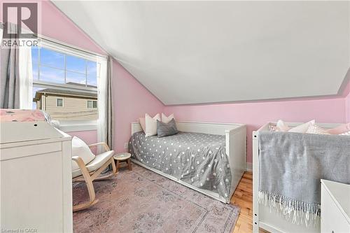 Hardwood-style flooring, white trim, and a window with natural light - 1231 Dunsmure Road, Hamilton, ON 