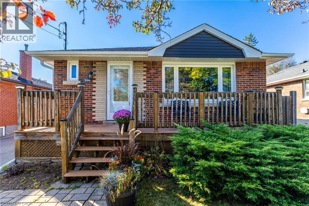 Brick exterior with a prominent front deck and railing - 366 East 17Th Street, Hamilton, ON