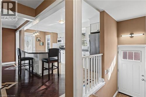 Kitchen island with a dark countertop and pendant lighting - 366 East 17Th Street, Hamilton, ON 
