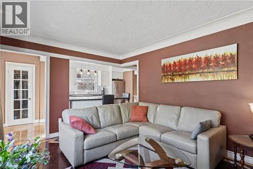 Wood-finish flooring, white crown molding, and a white French door with glass panels - 366 East 17Th Street, Hamilton, ON 