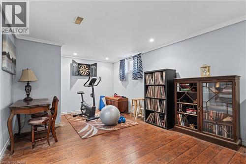 Recessed lighting, crown molding, wood-finish flooring, and a window with a patterned curtain - 366 East 17Th Street, Hamilton, ON 