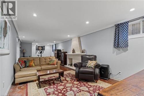 Recessed ceiling lighting, wood-finish flooring, and a white painted brick fireplace - 366 East 17Th Street, Hamilton, ON 