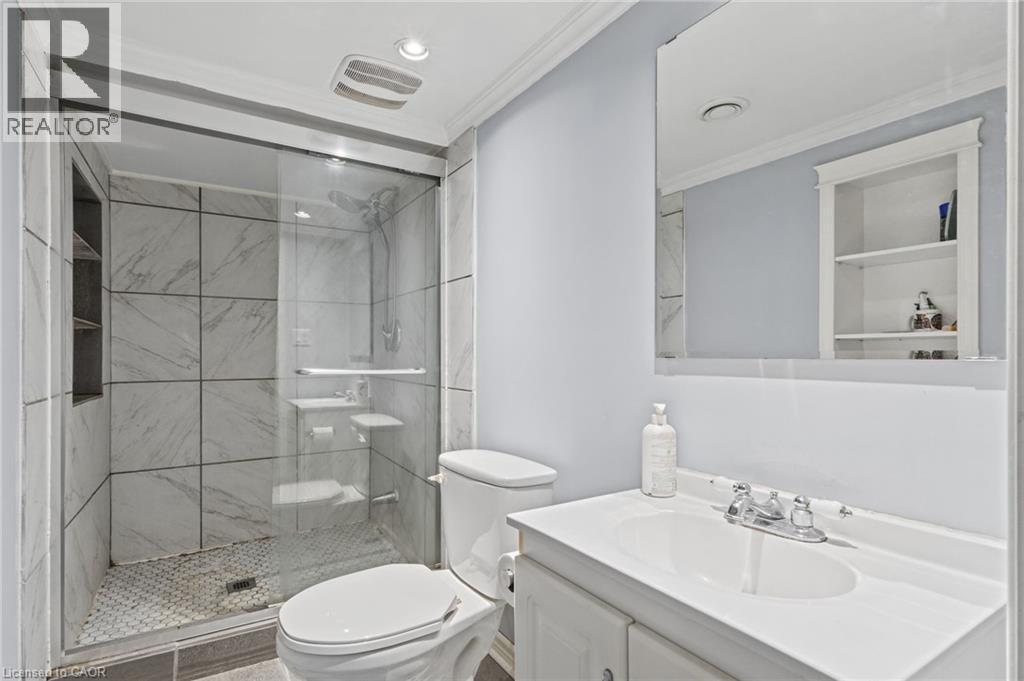 Shower with glass enclosure, large format tile walls, and a recessed niche - 366 East 17Th Street, Hamilton, ON