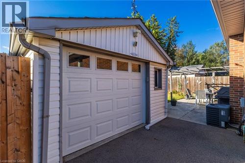 Attached garage with an overhead door featuring transom windows - 366 East 17Th Street, Hamilton, ON 
