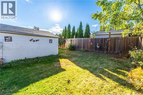 Expansive grassy yard with a wood-panel fence and established perimeter trees - 366 East 17Th Street, Hamilton, ON 