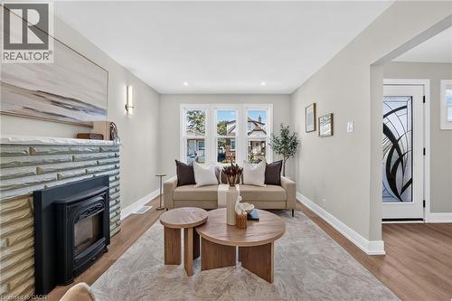 Wood-finish flooring, recessed lighting, and a stone-clad fireplace - 215 Paling Avenue, Hamilton, ON 