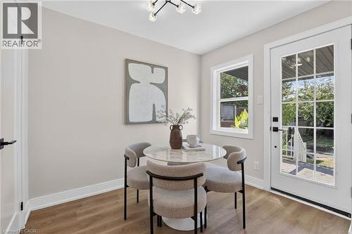 Wood-finish flooring, white trim, recessed window, glass panel door, and modern overhead lighting - 215 Paling Avenue, Hamilton, ON 