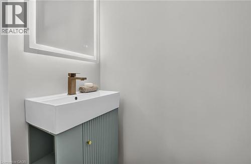 Modern vanity with an integrated rectangular basin, featuring a bronze-finish faucet - 215 Paling Avenue, Hamilton, ON 