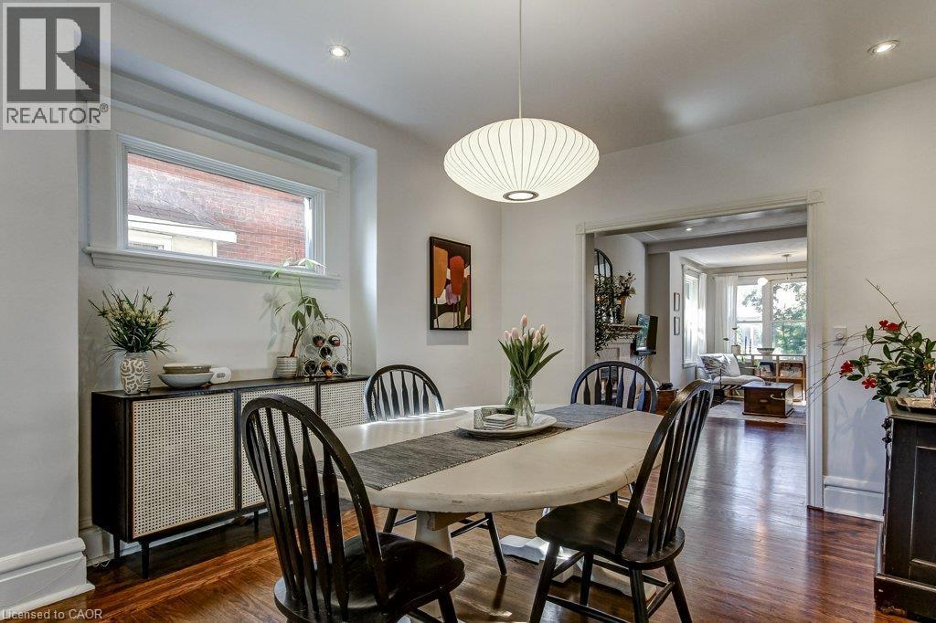 Warm wood-finish flooring, recessed lighting, and a modern pendant light fixture - 43 Rosslyn Avenue S, Hamilton, ON