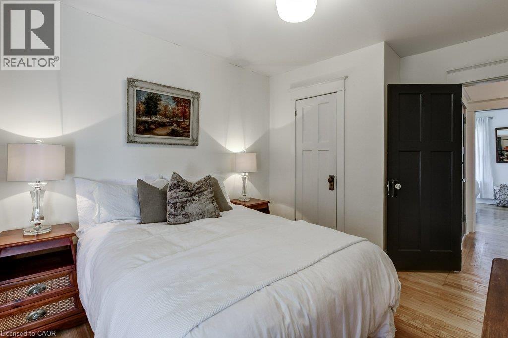White walls with a contrasting dark paneled door and white paneled door - 43 Rosslyn Avenue S, Hamilton, ON