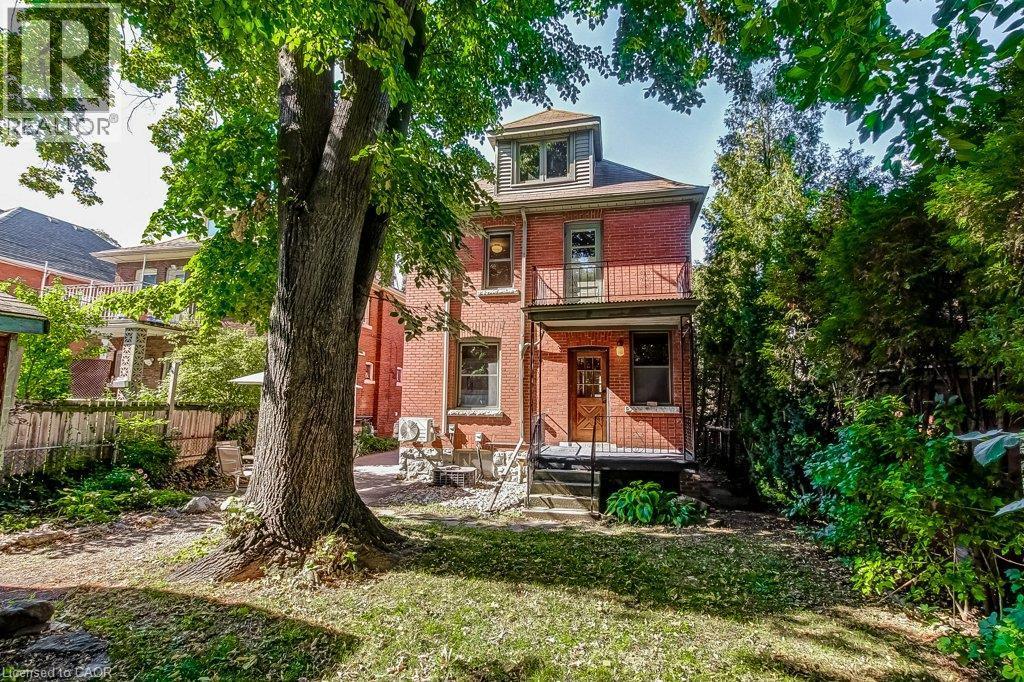 Red brick facade with a built-in balcony and exterior steps - 43 Rosslyn Avenue S, Hamilton, ON
