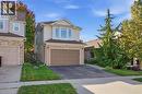 Two-story residence featuring siding and brick facade, an attached garage, and a paved driveway - 104 Amanda Walk, Cambridge, ON 