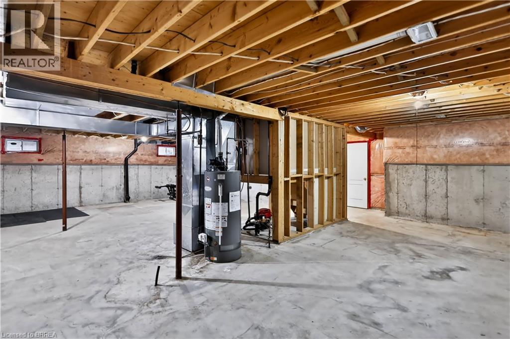 Unfinished basement with exposed ceiling joists, concrete flooring, and partial wall framing - 19 Hyslop Drive, Caledonia, ON