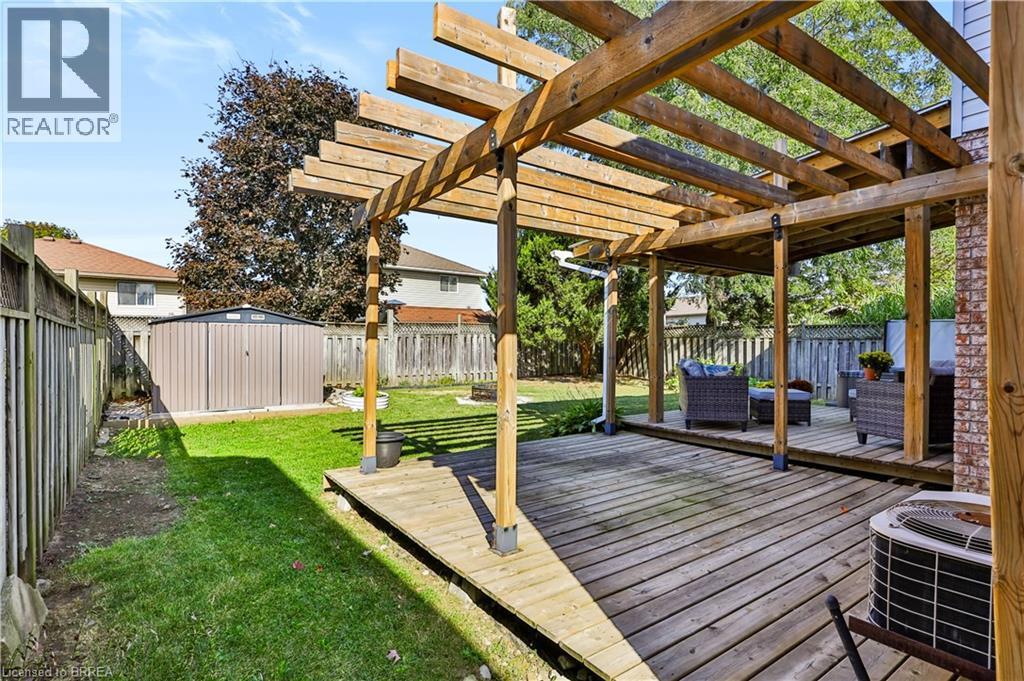 Expansive wooden deck with an integrated wood pergola - 19 Hyslop Drive, Caledonia, ON