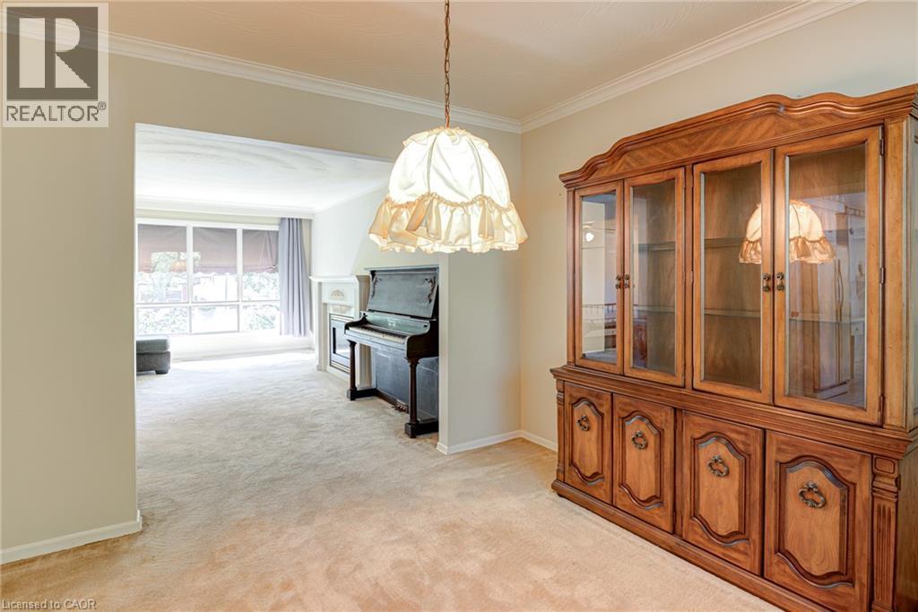 Crown molding throughout, recessed archway, large bay window, and a white mantel - 8 Bonnylyn Drive, Kitchener, ON