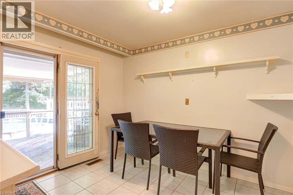 Tiled flooring, built-in shelving, and a sliding glass door providing exterior access to a deck - 8 Bonnylyn Drive, Kitchener, ON