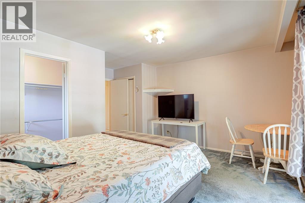 Neutral-toned walls enhance the space, complemented by a ceiling-mounted light fixture - 8 Bonnylyn Drive, Kitchener, ON