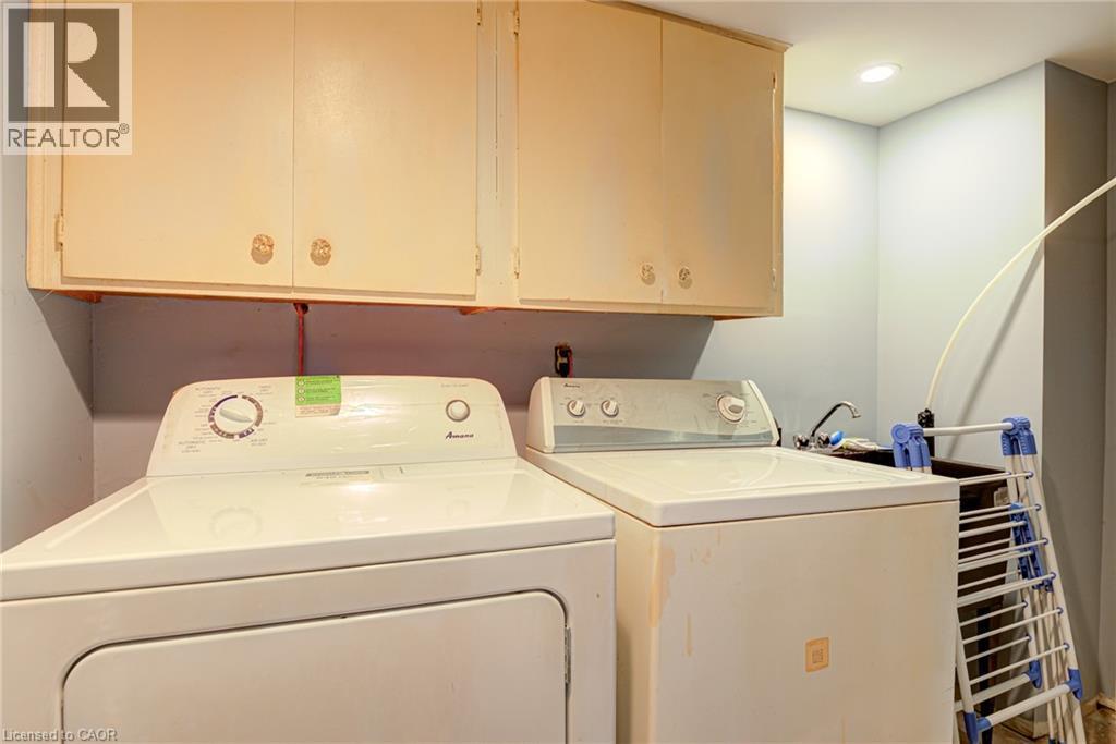 Laundry area with upper cabinetry, utility sink, and recessed lighting - 8 Bonnylyn Drive, Kitchener, ON