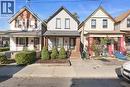 Two-story residential structure featuring light-colored siding and a dark roof - 73 Clinton Street, Hamilton, ON 