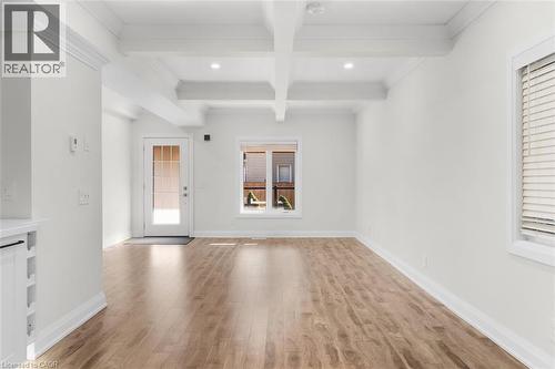 Coffered ceiling with recessed lighting, wood-finish flooring, white walls, and a glass-paneled door - 73 Clinton Street, Hamilton, ON 